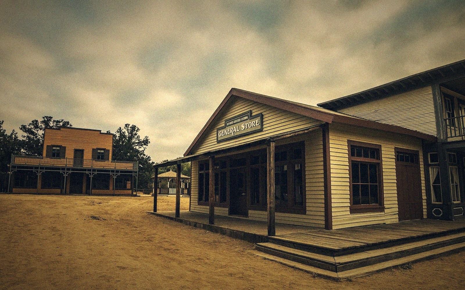 Wooden general store storefront on an empty dirt street in an old western town set