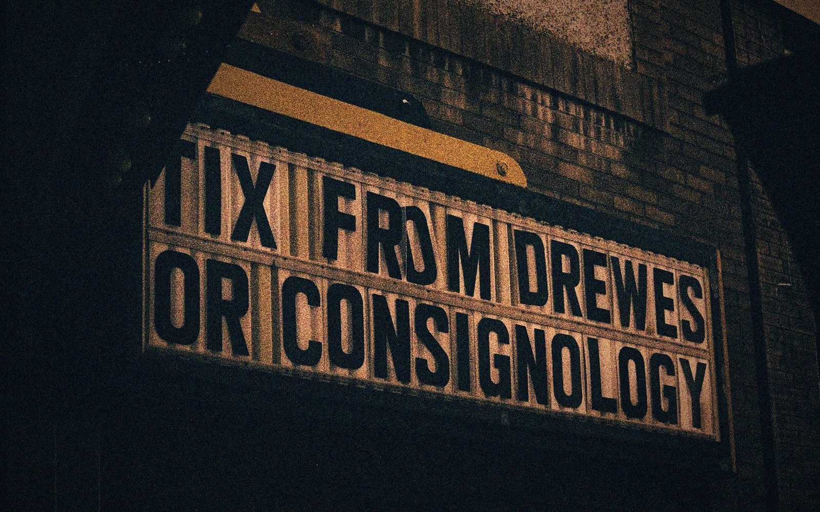 Hands setting letters on a cinema marquee
